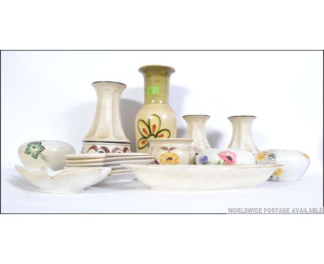 A collection of vintage and retro studio pottery vases by Radford pottery to include a trio of matching ones. All stamped to 