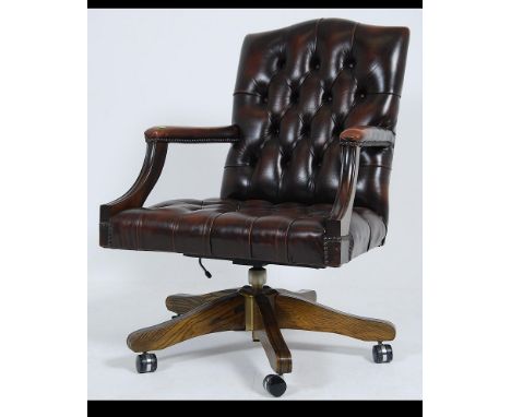 Antique Chesterfield Style mahogany and leather button back captains office swivel chair. The reeded quadruped base with cast