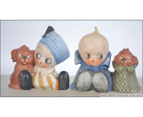 A pair of early 20th century Schafer &amp; Vater Figural bisqueware match holders to include baby boy in cloak with dog in cl