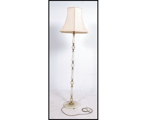 A 1950's vintage onyx based standard lamp with shade atop. Measures 178cm high x 53cm wide.