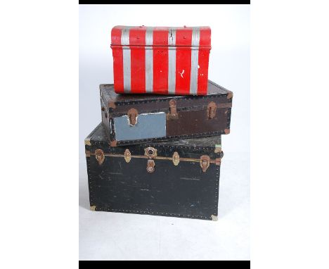 A collection of three vintage 20th century steamer trunks. Two wooden and canvas bound along with a painted tin trunk.