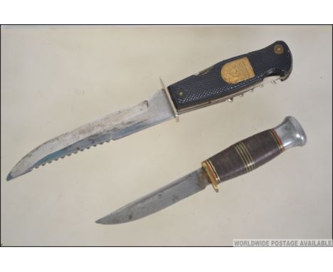 A German made Solingen multi bladed hunting knife along with another vintage hunting knife both in leather sheafs. Measures: 