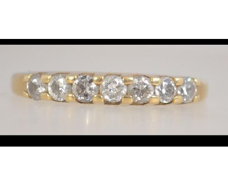 A hallmarked 18ct gold and diamond ring set with 7 round cut diamonds in a prong setting. Import Marked for London. Weight 2.