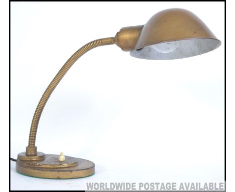 An early 20th Century industrial goose neck desk lamp. The domed swivel shade on an adjustable goose neck column terminating 