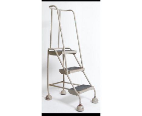 A stunning retro / vintage industrial mid 20th century metal tubular Library / factory ladder. Having four steps with rails t