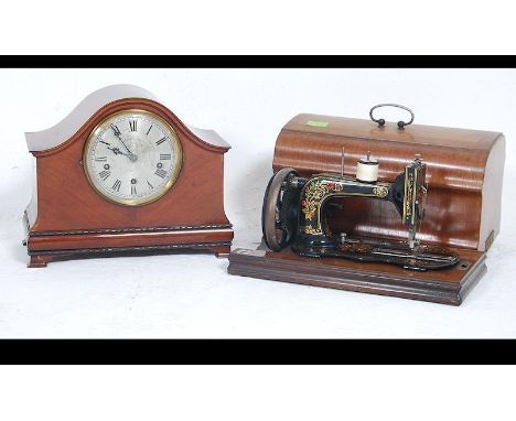 An early 20th century napoleons hat mantel clock with the dial marked for Wales & McCulloch, Cheapside, London. Together with