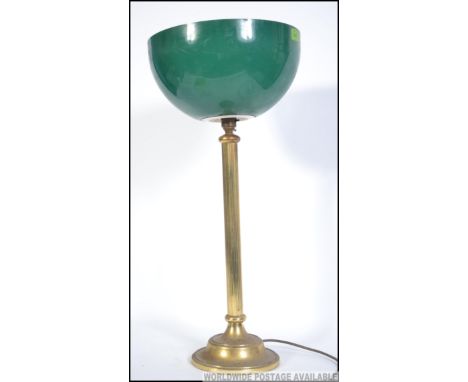 A vintage brass bankers desk lamp with neo classical style lamp base and two tone uplighting green and white shade