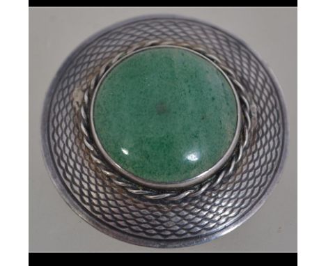 A Scottish silver and jade hallmarked roundel brooch. The brooch with Edinburgh assay marks for 1961. Total weight 10.2g / 3.