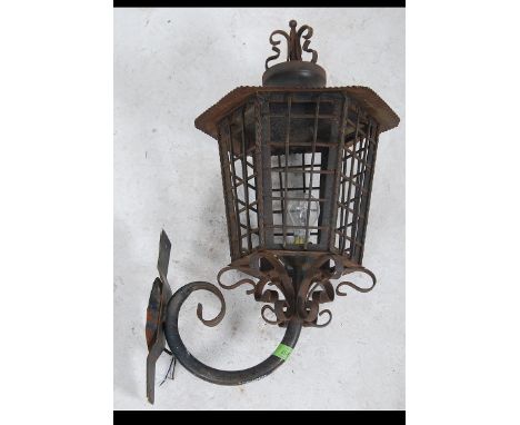 A fantastic 19th century Victorian cast metal outside light complete with the original wall bracket having glazed panels and 