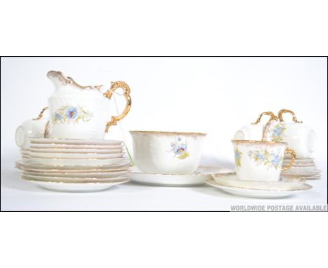 A stunning hand painted 19th century bone China Victorian tea set beautifully painted with blue and rouge flowers. Consisting