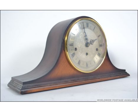 A mid century napoleons hat oak mantel clock by St James of London having silvered dial with Westminster chime movement. Meas