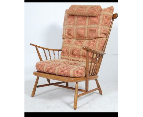 A contemporary Ercol 741 pattern Windsor armchair with good contemporary cushions to the beech and elm wood frame. Measures 1