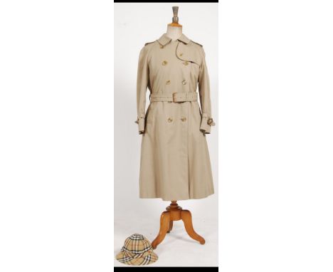 A Burberry ladies raincoat together with a Burberry rain hat and a Burberry ladies waistcoat - Gillette. Approx size 12 - 14.