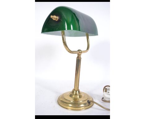 A 20th century bankers desk / work lamp having brass base and upright support below the green glass shade. Measures: 36cms hi