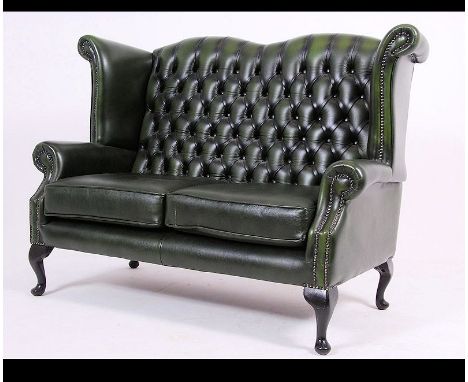 Antique Chesterfield Style mahogany and leather button back two seat sofa settee being raised on cabriole legs upholstered in