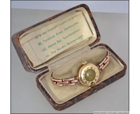 A vintage circa 1930's ladies 18ct gold wrist watch the half hunter case with white enamel face and Chronometer Everhart Swis