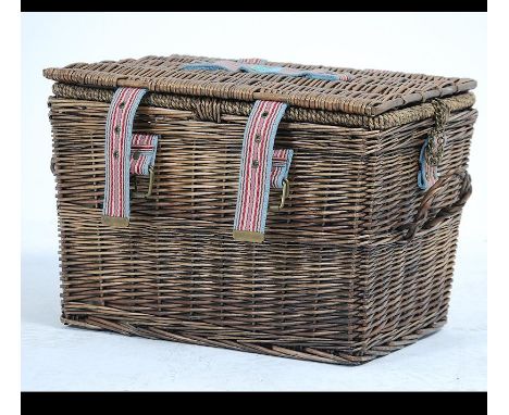 A contemporary Joule whicker hamper complete with contents together having canvas strapping and applications. Measures: 31cms