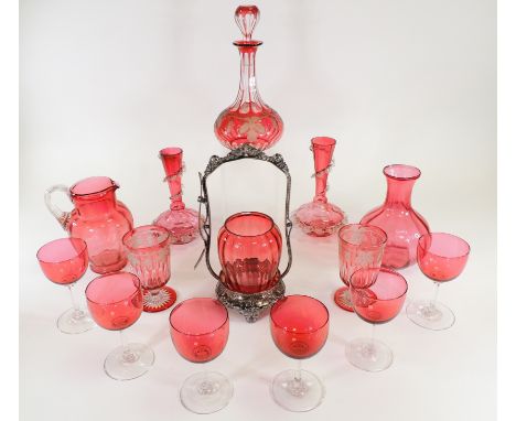 A small quantity of cranberry glass,  to include a decanter with grape and vine design, height 25cm, and two raised and foote