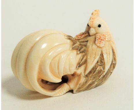 A Japanese Meiji period (1868-1912) or early Taisho (1912 - 1926) ivory netsuke in the form of a cockerel, with intricately c