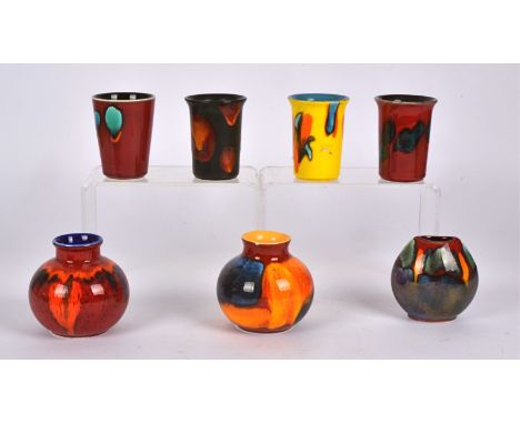Seven pieces of Poole Pottery,  to include four beaker shaped vases, height 9.5cm, two bulbous squat vases form the Reflectio