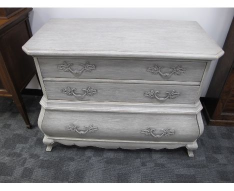A contemporary Louis XV style bombe commode,   three long drawers, distressed limed finish, possible Oka, 110cm x 58cm x 86cm