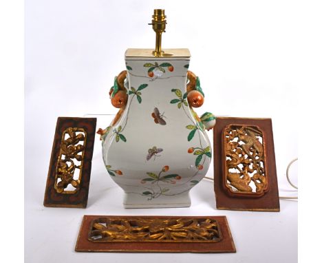 A contemporary Asian lamp base, decorated with butterflies and foliage upon a white ground,  the two handles modelled as pass