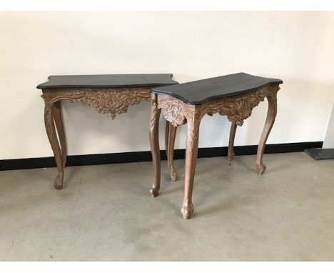 A pair of contemporary Louis XV style console side tables, with black painted tops and destressed moulded lowers, 90cm wide, 