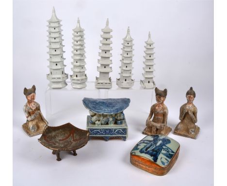 Three Chinese Tang style earthenware figures of kneeling female attendants,  each with a slightly altered pose, one with high