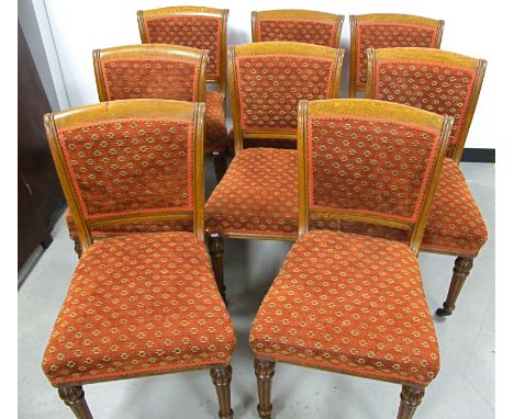 A set of eight 19th Century oak dining chairs,  in the style of Gillows, with padded backs and overstuffed seats upholstered 