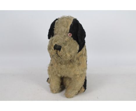 Unknown Maker - A large black and white sitting dog, he is straw filled and appears of good quality and sits 42 cm high. The 