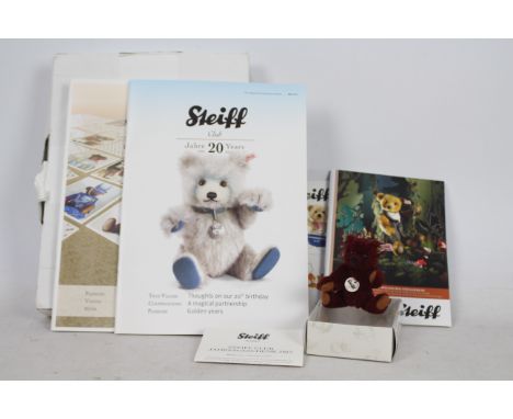 Steiff - A boxed miniature alpaca hair 'Annual Gift 2012' bear - The burgundy bear has plastic eyes, wool felt paws and nose.