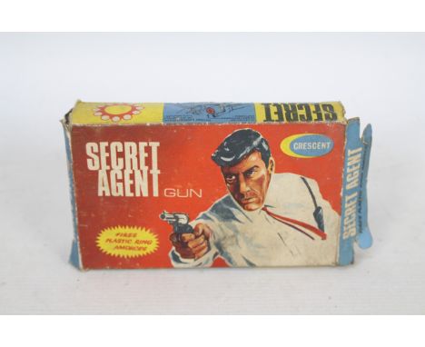 Crescent - A boxed Crescent Secret Agent Gun in the early style box # 136. The gun appears in Good condition with some signs 