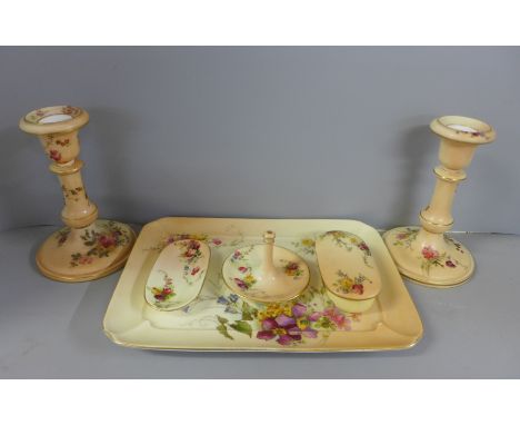 A Royal Worcester dressing table set, blush ivory with floral detail including a pair of candlesticks, circa 1909, one candle