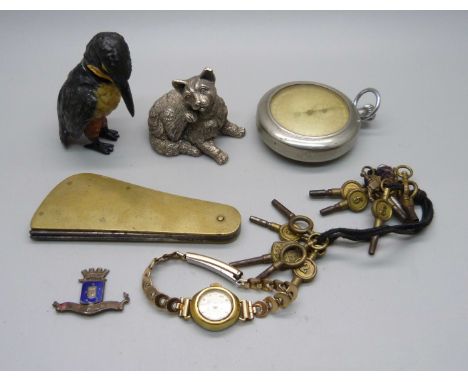 A silver covered model cat, a nodding cold painted model bird, a fleam, watch keys, etc. 