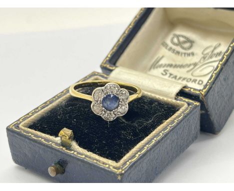 A Vintage Sapphire and Diamond Flowerhead Cluster Ring, millegrain set with old cut stones, indistinctly stamped (finger size