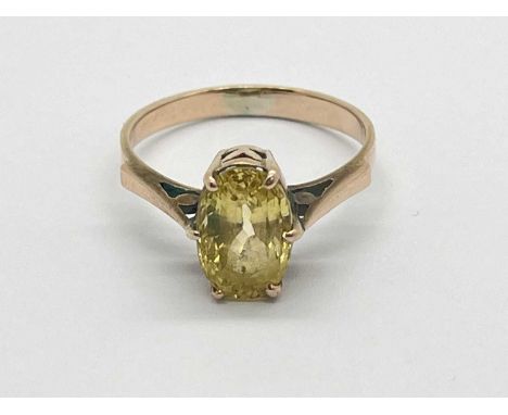 An Oval Single Stone Dress Ring, claw set between tapered shoulders.