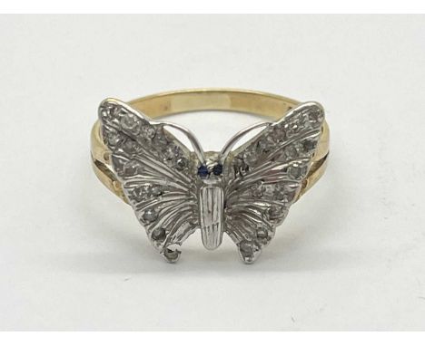 A 9ct Gold Diamond Butterfly Ring, sapphire set eyes between bifurcated band (finger size M) (2.5grams).