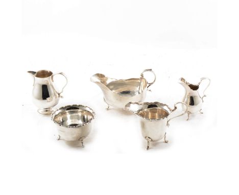 A silver sauce boat, Walker &amp; Hall, Sheffield 1909, double scroll handle with leaf thumb piece, on three hoof feet, a sug