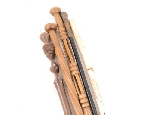 Three Ethnic hardwood walking-sticks, 95cm and smaller; an ebonised cane; and another Ethnic stick. (5)