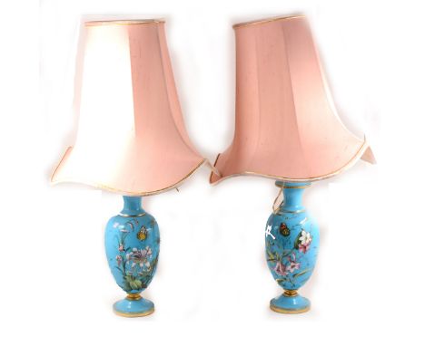 A pair of French opaque blue glass vases, decorated with flowers and butterflies, serving as lamp bases, 32cm.