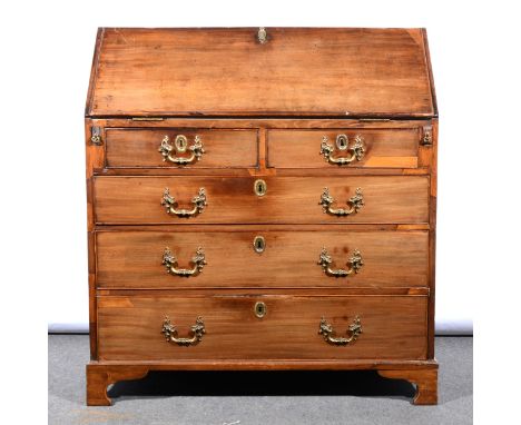 A George III mahogany bureau, fall front enclosing an interior fitted with writing surface, drawers, cupboards and pigeon hol