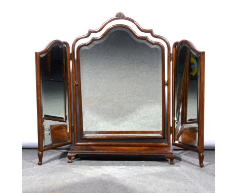 Stained wood and figured walnut triptych toilet mirror, adjustable arched centre plate, platform base with ogee bracket feet,