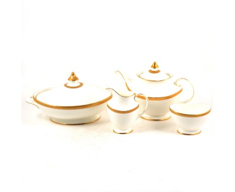 A Royal Doulton bone china dinner service, Royal Gold, including tea and coffee ware.