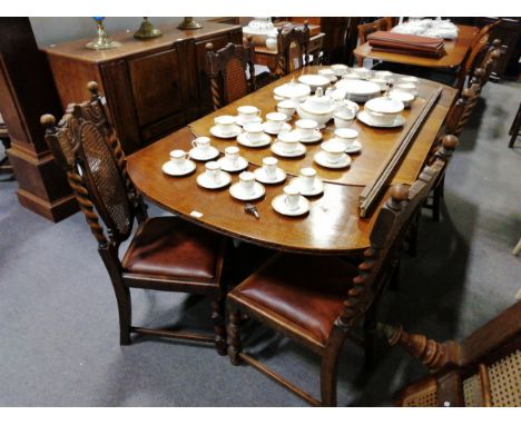 An oak dining room suite, comprising an oak draw-leaf table, rounded ends, bulbous cup and cover supports, extending to 212cm