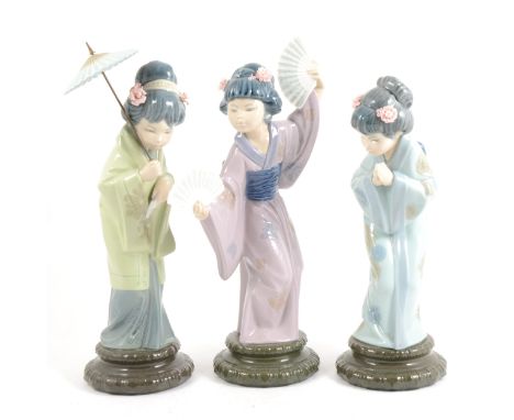 Three Lladro figures of Japanese girls, one with a parasol, 31cm. (3) (Qty: 3)