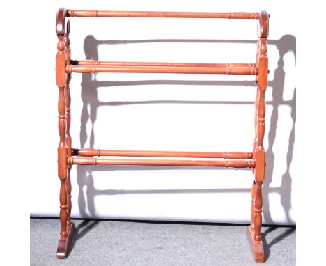 A stained beechwood standard lamp, 150cm, a modern towel rail and a modern pine luggage stand, (3)..