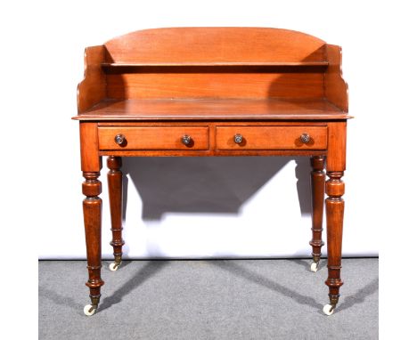 A Victorian mahogany washstand, three-quarter gallery with a shelf back, fitted with two frieze drawers, turned and ringed le