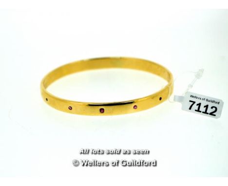 9ct yellow gold fixed bangle set with five small rubies, gross weight 33.7 grams