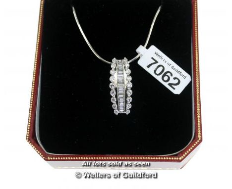 Diamond set pendant, graduating baguette cut diamonds channel set through the centre, with round brilliant cut diamonds claw 