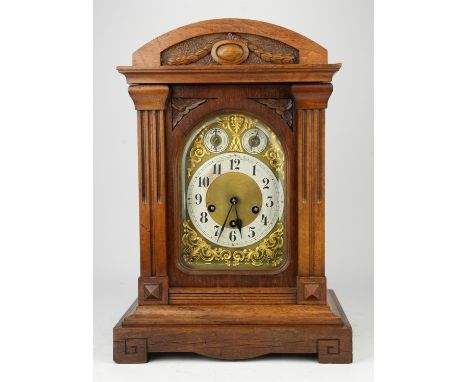 An Edwardian oak cased mantel clock, the case of architectural design, the dial with Arabic numeral chapter ring, with subsid
